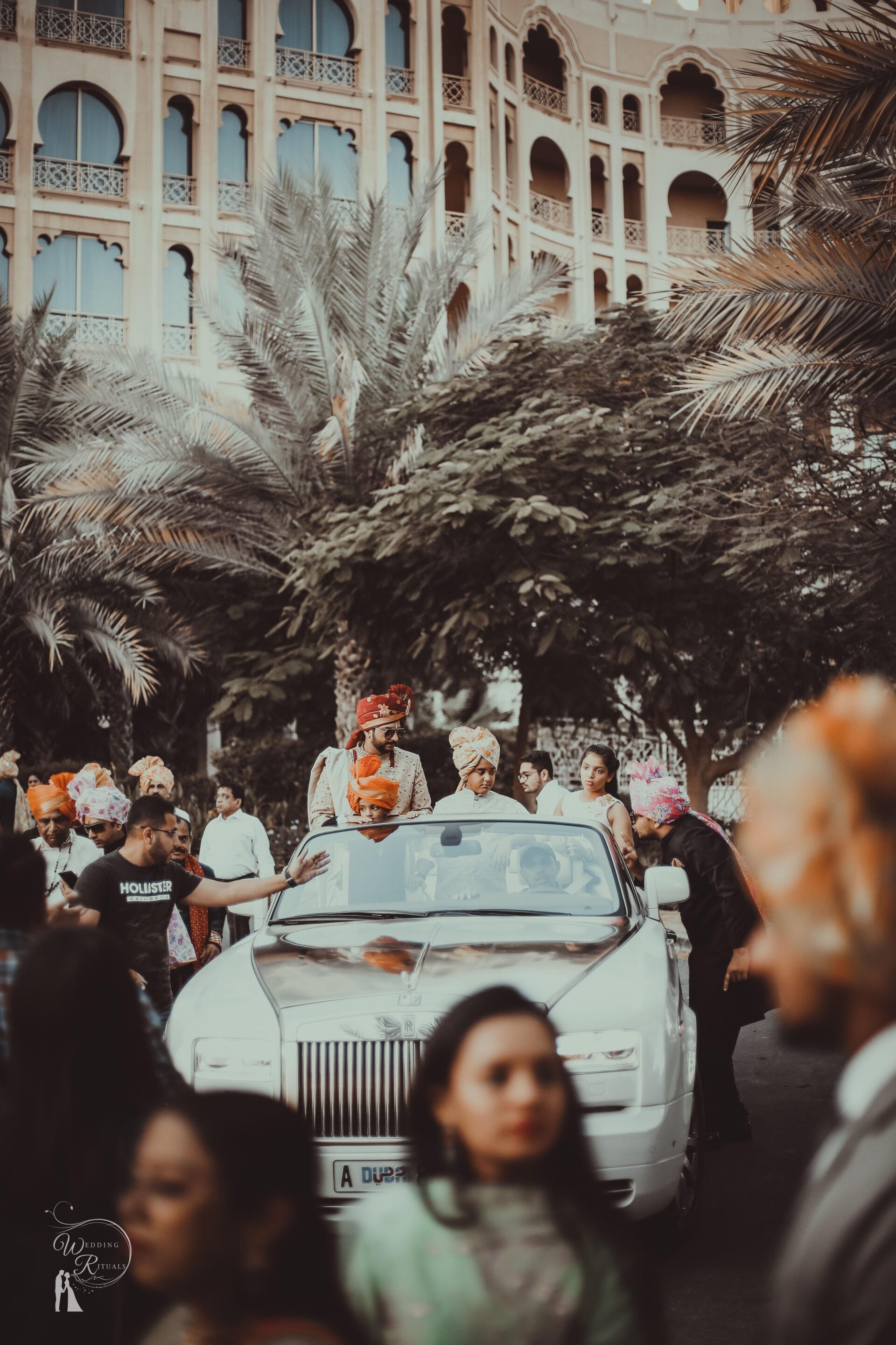 Indian groom riding in a rolls Royce at a hotel in Dubai